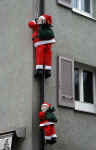 Santas climbing a drainpipe.